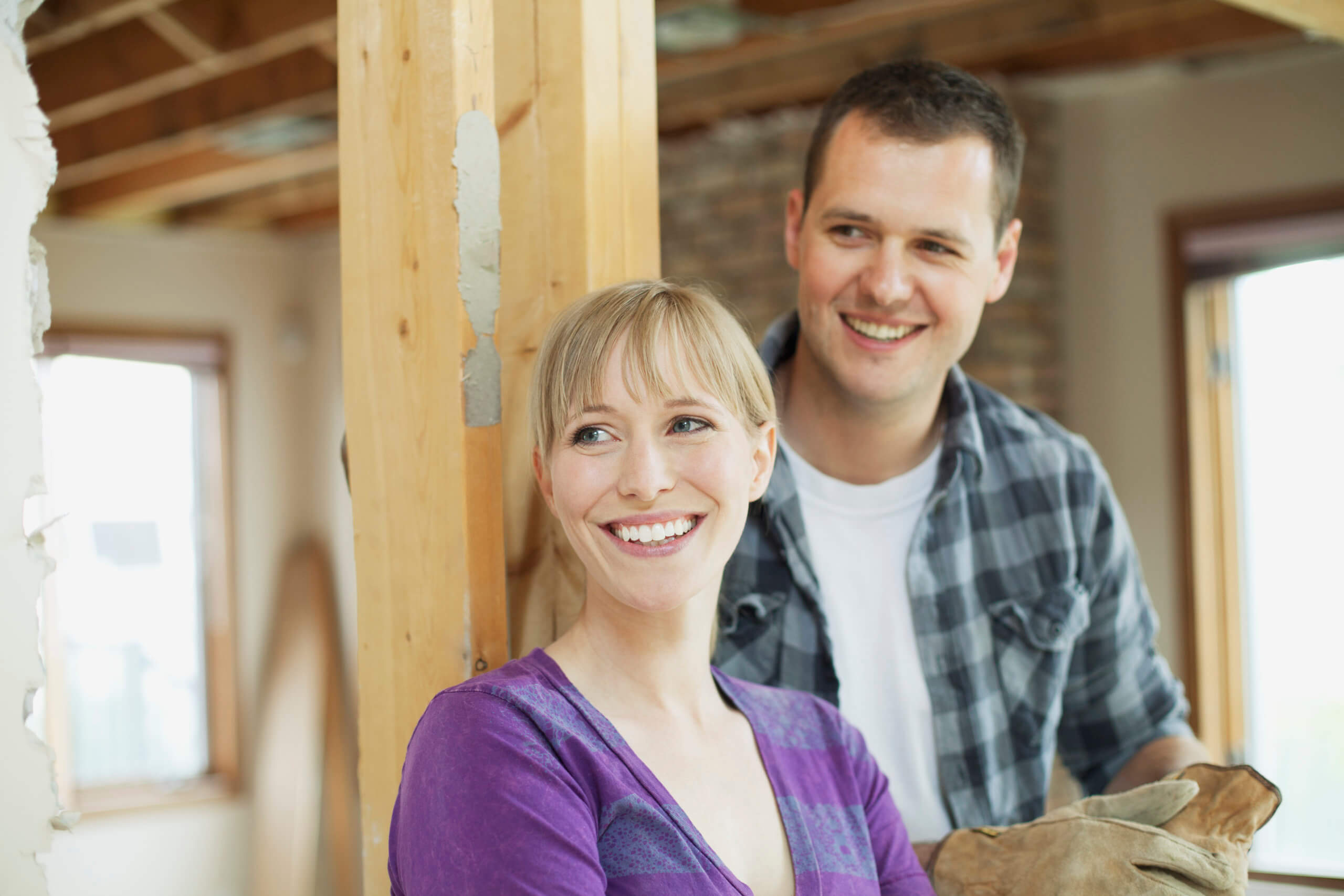 happy, mid adult couple in renovation