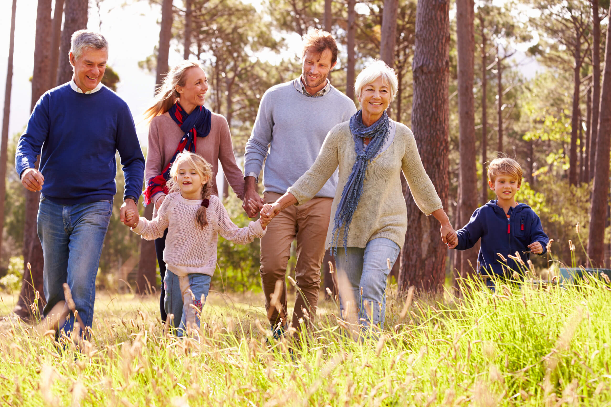 Happy multi-generation family walking in the countryside