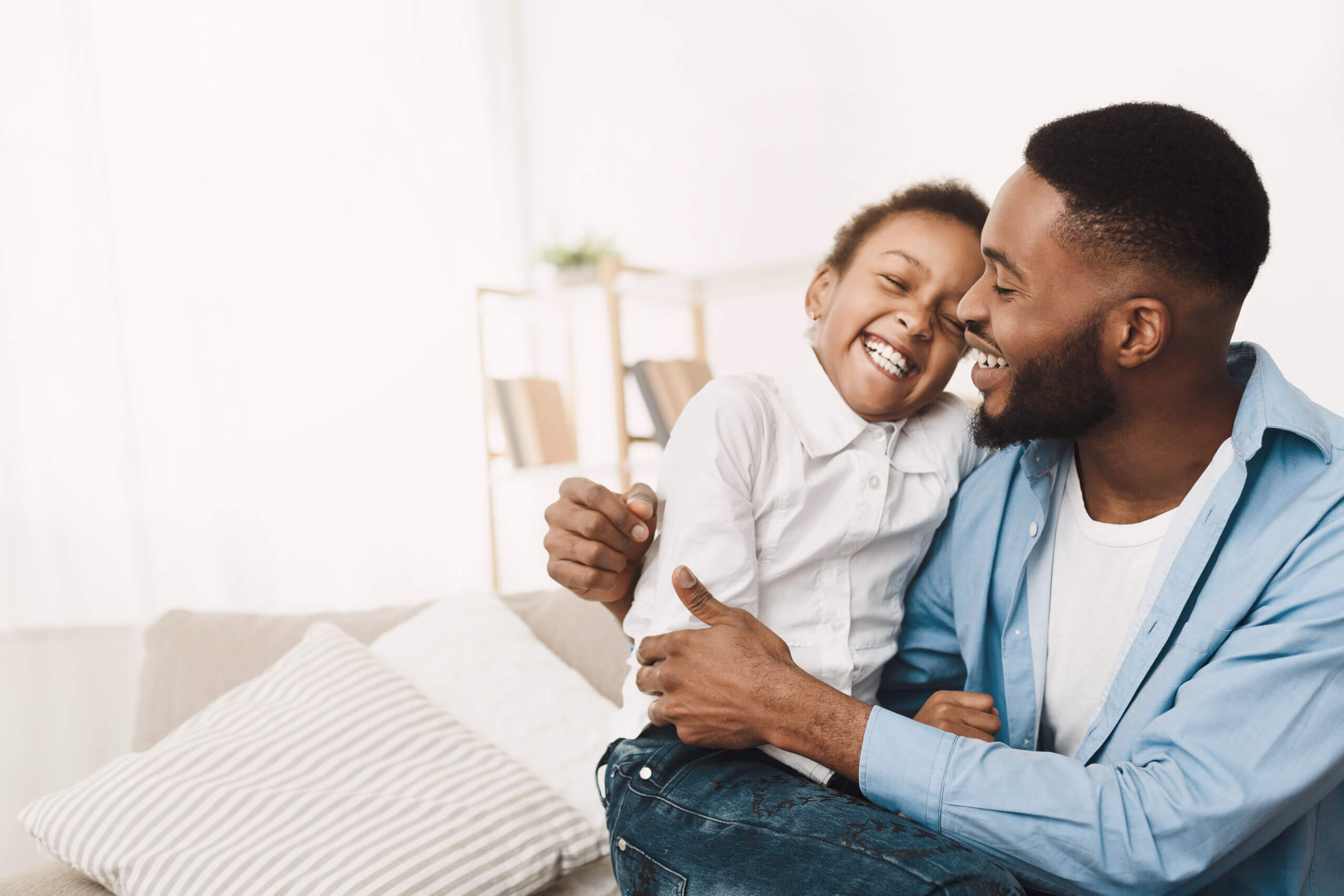 Father Tickling Daughter, Having Fun And Playing Together At Home