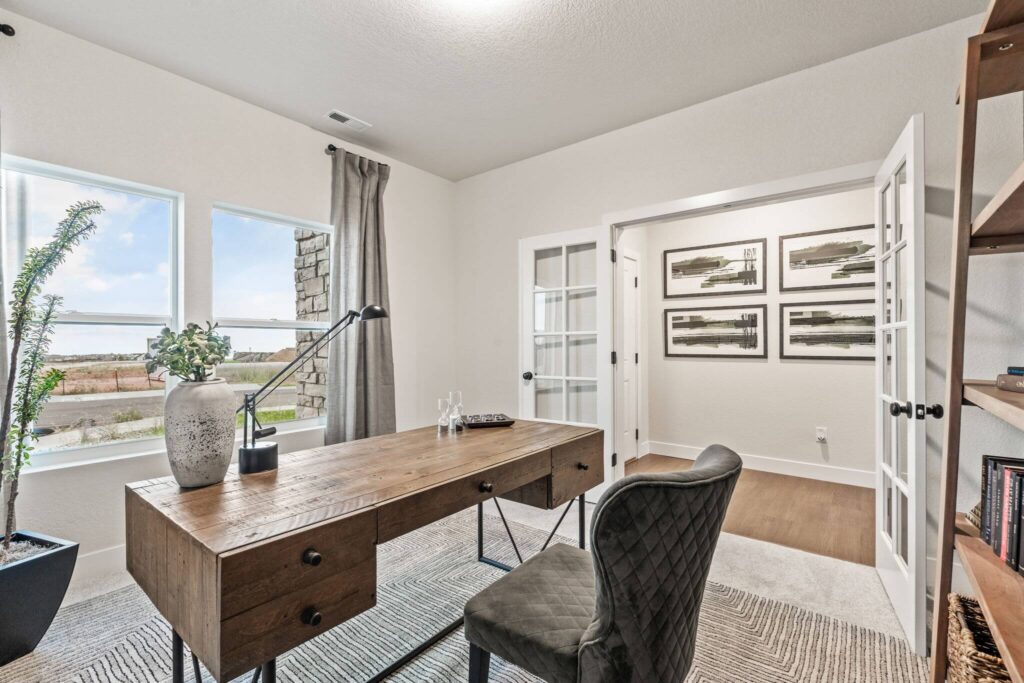 Alternate angle of the office showing desk by windows and French doors into hall.