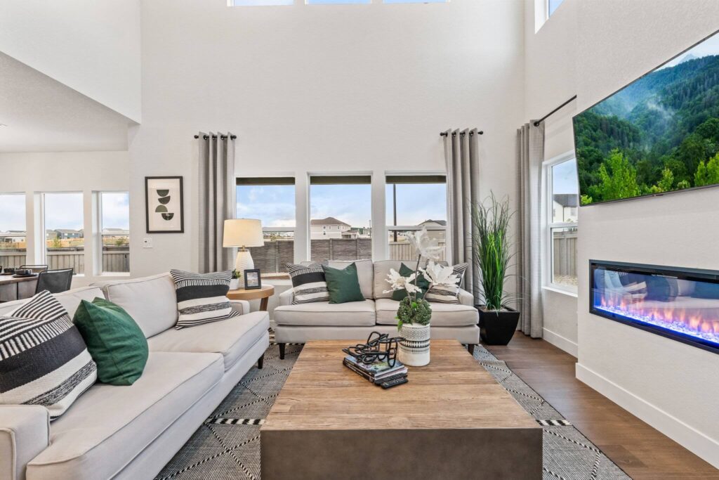 Cozy living space with matching light sofas, a wood coffee table, and a horizontal fireplace.