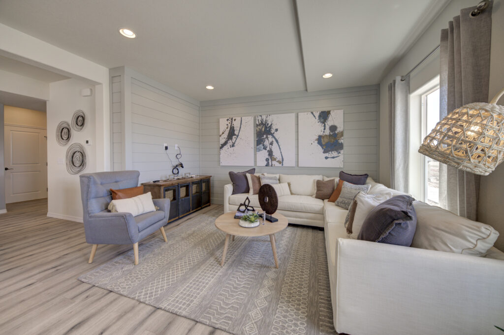 Cozy living room view with sectional sofa, armchair, decorative console, and wall art above sofa.