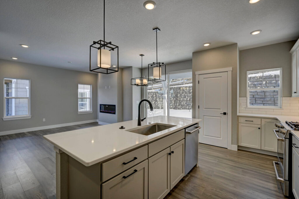 Open-plan kitchen and living area with large island and pendant lighting