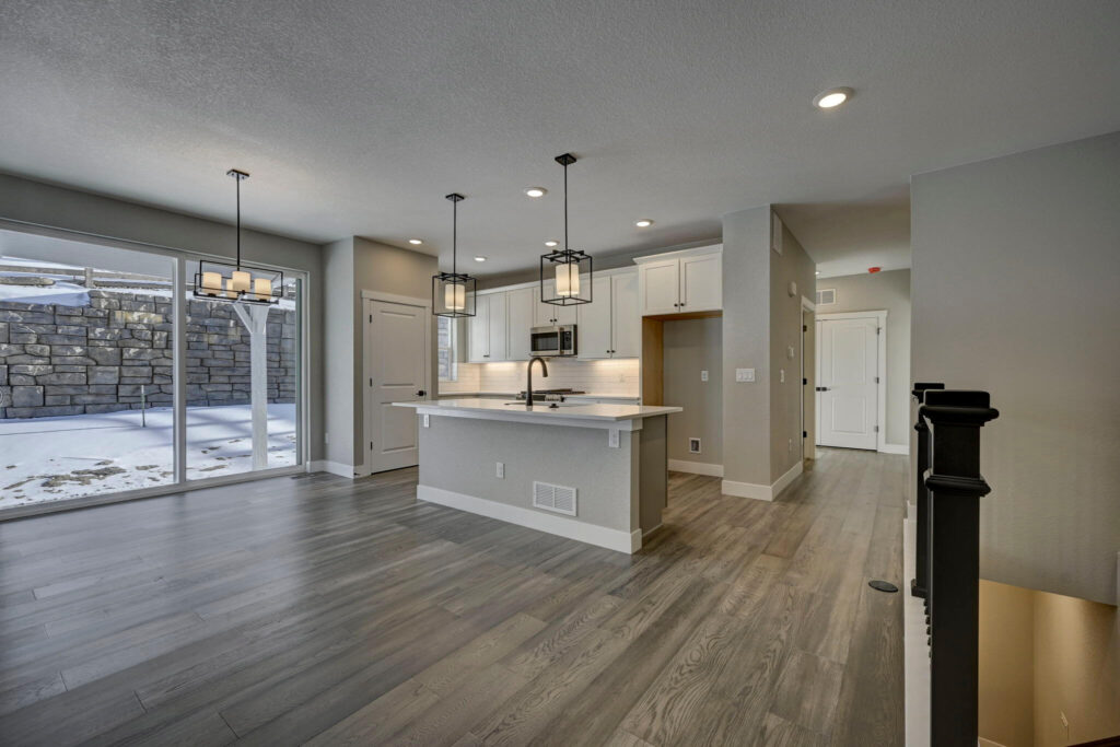 Spacious kitchen and dining area with large sliding glass doors to a snowy yard.