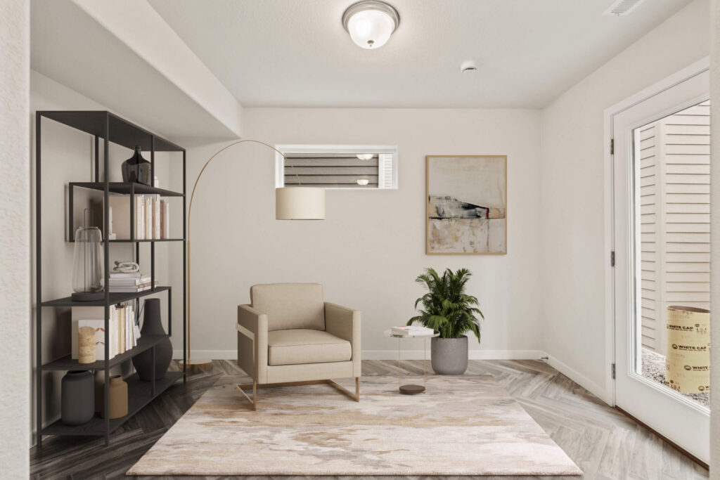 Small furnished sitting area with an armchair, floor lamp, shelving unit, and area rug.