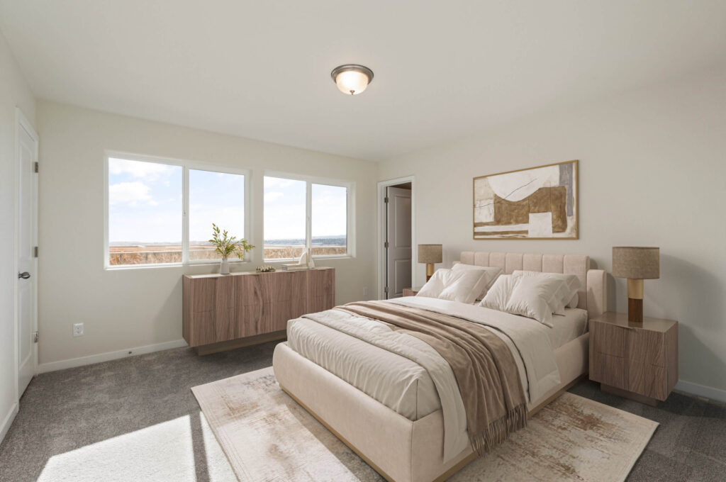 Staged bedroom with upholstered bed, two nightstands, and three windows on one wall.