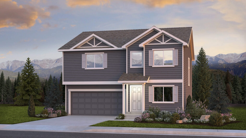 Two-story gray house with decorative gables, attached garage, and landscaped yard at sunset.