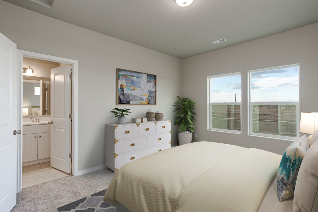 Staged bedroom with bed, dresser, artwork and two windows showing exterior view.