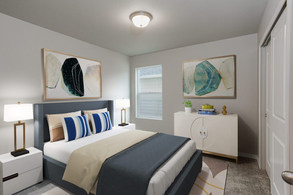 Staged bedroom with dark upholstered bed, two bedside tables, artwork and a small cabinet by the window.