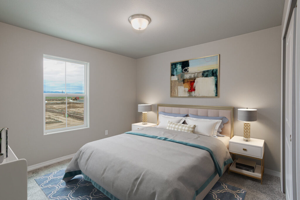 Staged bedroom with a bed, two nightstands and a window showing a dirt lot outside.