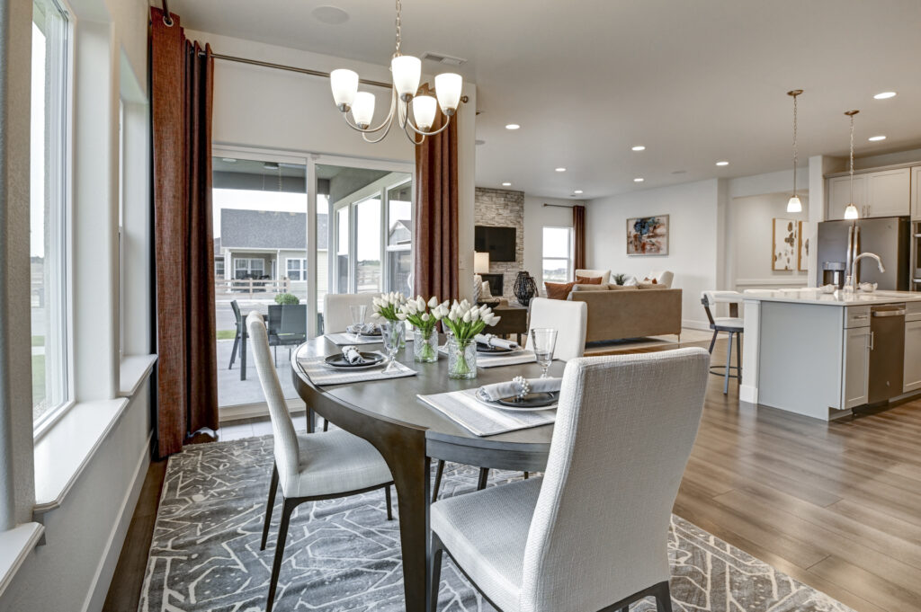 Dining area beside sliding glass doors looking into a connected living and kitchen space.