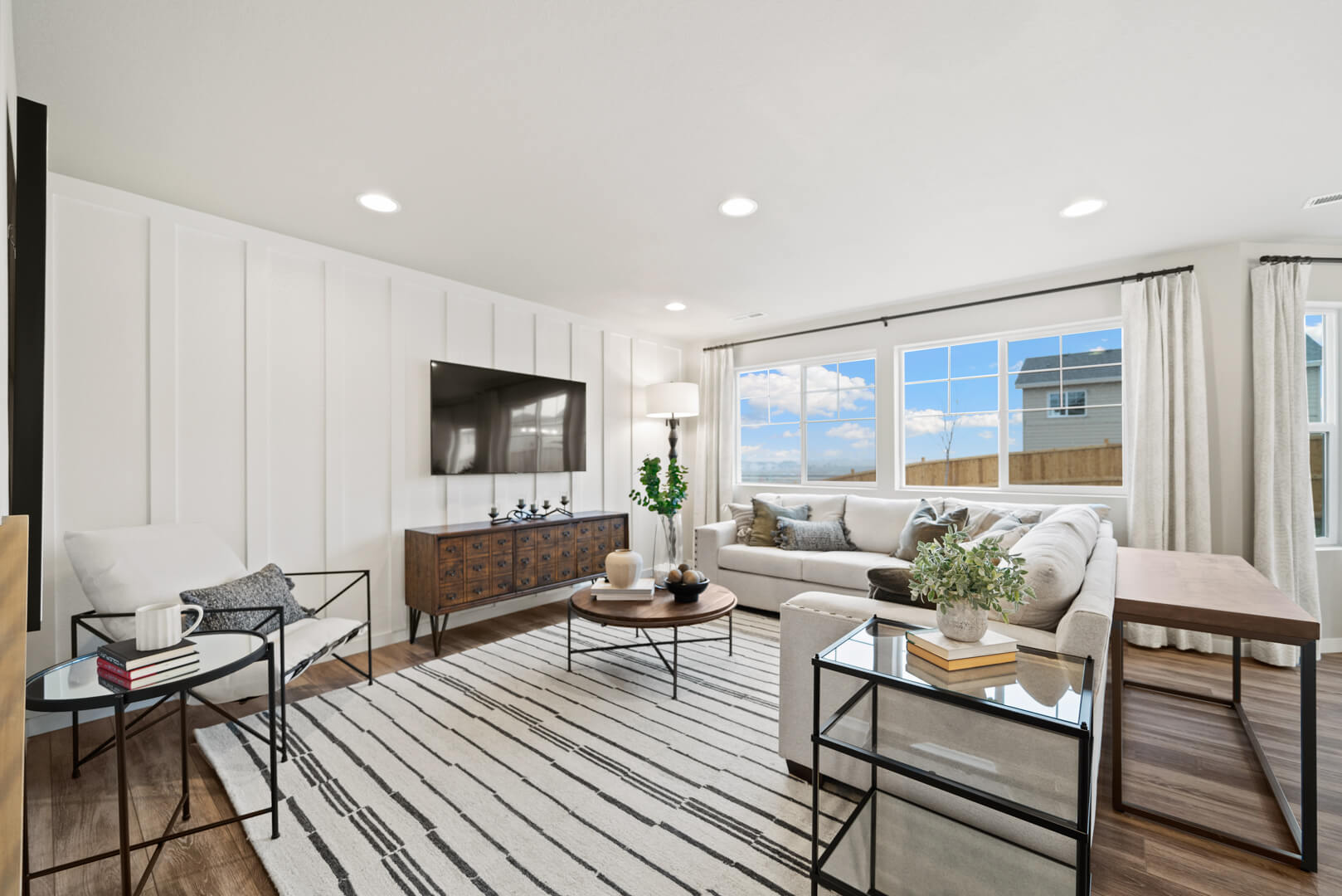 A bright Challenger Homes living room with coordinated finishes and furnishings
