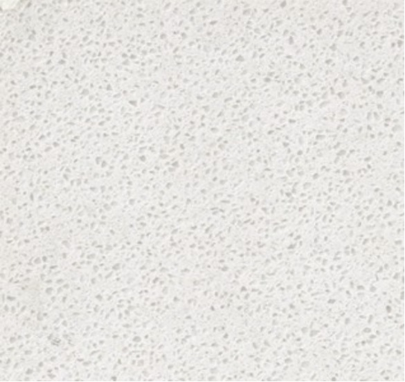 Close-up of a light off-white textured surface with small irregular speckles.